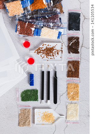 A set for handmade home crafts of colored diamond mosaic on a table top and vertical view A set for handmade home crafts of colored diamond mosaic on a table top and vertical view 141105534