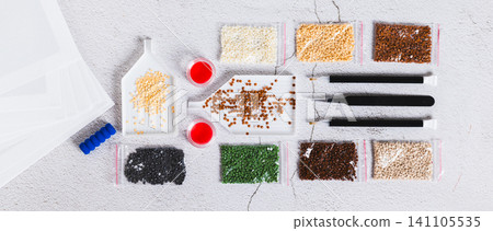 A set for handmade home crafts of colored diamond mosaic on a table top view web banner 141105535