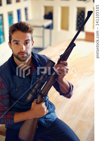 Hunter, weapon and portrait of man with gun for game shooting, adventure and hobby with confidence. Sports home and serious face of person in cabin with rifle, pride and sportswear for hunting Hunter, weapon and portrait of man with gun for game shooting, adventure and hobby with confidence. Sports home and serious face of person in cabin with rifle, pride and sportswear for hunting 141105585