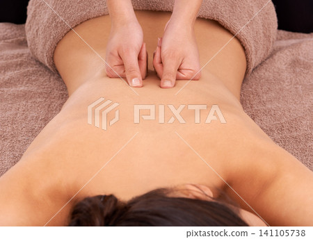 Hands, health and woman with back massage at spa for wellness, self care and grooming treatment. Skin, calm and female person with masseuse for body routine on table for zen or peace resort. Hands, health and woman with back massage at spa for wellness, self care and grooming treatment. Skin, calm and female person with masseuse for body routine on table for zen or peace resort. 141105738