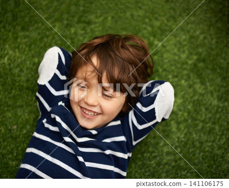 Child, relax and happy on green grass for holiday, vacation and outdoor wellness in nature. High angle or above of a young kid, boy or student on lawn with excited face for playground, park or spring Child, relax and happy on green grass for holiday, vacation and outdoor wellness in nature. High angle or above of a young kid, boy or student on lawn with excited face for playground, park or spring 141106175