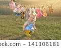 A funny laughing boy is depicted against the backdrop of a pile of stuffed animals hanging from a clothesline. 141106181