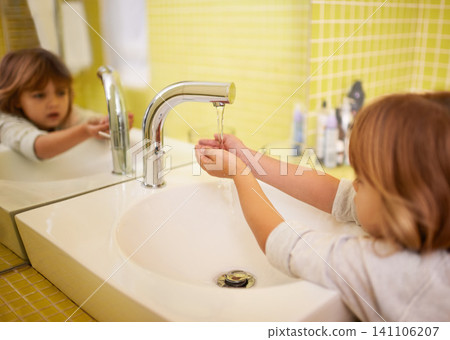 Girl, bathroom and hands with washing, hygiene and cleaning with mirror at home. Child, faucet and reflection for healthy, development and childhood with morning routine at house for cleanliness Girl, bathroom and hands with washing, hygiene and cleaning with mirror at home. Child, faucet and reflection for healthy, development and childhood with morning routine at house for cleanliness 141106207