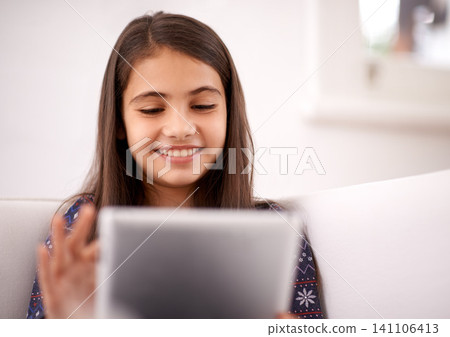 Relax, couch or happy child with tablet for elearning, playing games or streaming videos on a movie website. Education, online and girl in home with technology to download on app or reading ebook Relax, couch or happy child with tablet for elearning, playing games or streaming videos on a movie website. Education, online and girl in home with technology to download on app or reading ebook 141106413