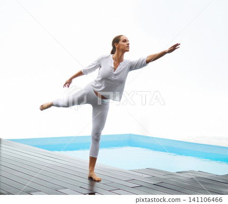 Yoga, woman and pool deck outdoor with balance, peace and calm by water with zen at home. Wellness, health and female person on a patio with stretching, pilates and spiritual practice at a house Yoga, woman and pool deck outdoor with balance, peace and calm by water with zen at home. Wellness, health and female person on a patio with stretching, pilates and spiritual practice at a house 141106466