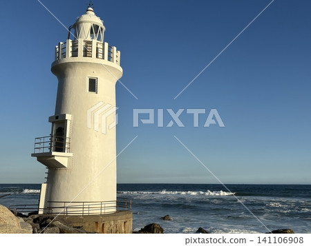 Lighthouse bathed in the setting sun Lighthouse bathed in the setting sun 141106908