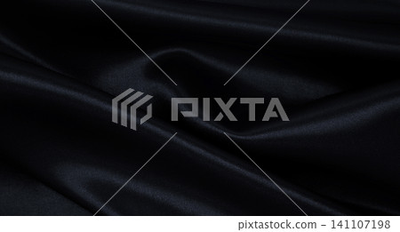 Smooth elegant black silk or satin luxury cloth texture as abstract background. Luxurious background design Smooth elegant black silk or satin luxury cloth texture as abstract background. Luxurious background design 141107198