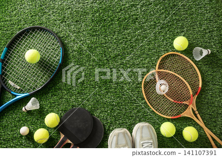 Sports equipment flat lay on green artificial grass with copy space Sports equipment flat lay on green artificial grass with copy space 141107391