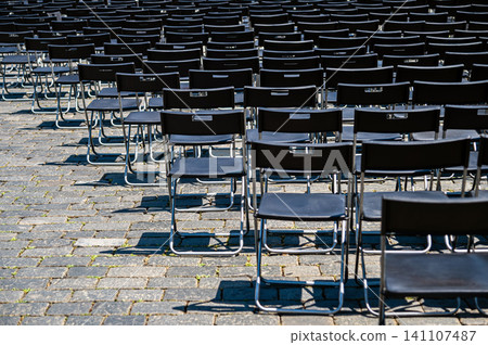 Chairs set up in Prague for an event on a sunny day Chairs set up in Prague for an event on a sunny day 141107487