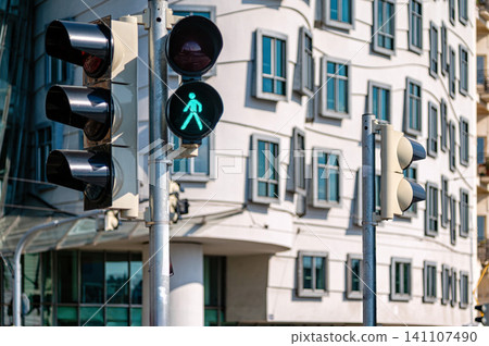 Green pedestrian light near unique building in Prague during daytime Green pedestrian light near unique building in Prague during daytime 141107490