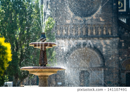 Fountain in Prague with water spraying near a historic building during daytime Fountain in Prague with water spraying near a historic building during daytime 141107491