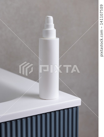 White pump cosmetic bottle mockup on blue bathroom vanity. Skincare cosmetic packaging White pump cosmetic bottle mockup on blue bathroom vanity. Skincare cosmetic packaging 141107589