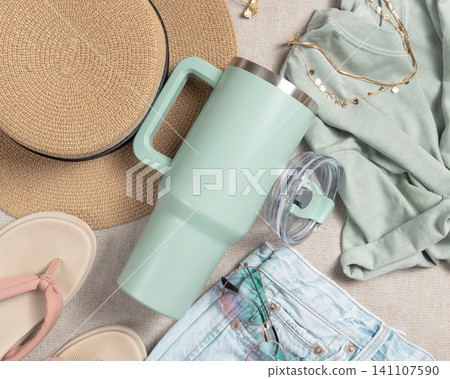 Blank sage green 40oz tumbler mockup, stainless steel travel thermos on denim and dark red sweatshirt Blank sage green 40oz tumbler mockup, stainless steel travel thermos on denim and dark red sweatshirt 141107590