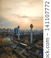 Urban landscape view with twin minarets against a sunset. 141107772