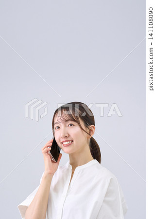 Young woman talking on a smartphone Young woman talking on a smartphone 141108090