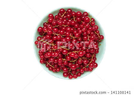 Red currants on blue plate isolated on white background. Fresh and vibrant food photography for healthy eating. Red currants on blue plate isolated on white background. Fresh and vibrant food photography for healthy eating. 141108141