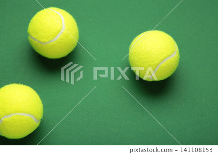 Three tennis ball on green background. Top view Three tennis ball on green background. Top view 141108153
