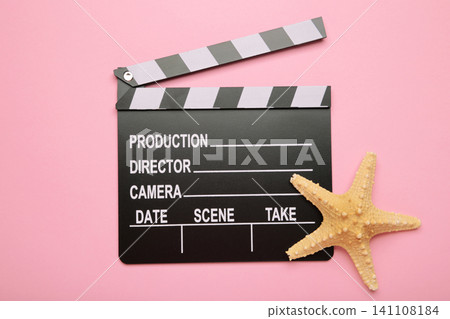 Summer holiday and vacation movie cinema marathon background Cinema clapper-board with starfish on pink background. Summer holiday and vacation movie cinema marathon background Cinema clapper-board with starfish on pink background. 141108184