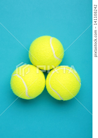 Bright yellow tennis balls on blue background. Vertical photo Bright yellow tennis balls on blue background. Vertical photo 141108242