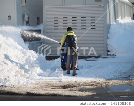 Snow removal using a small snowblower. Snow removal using a small snowblower. 141108308