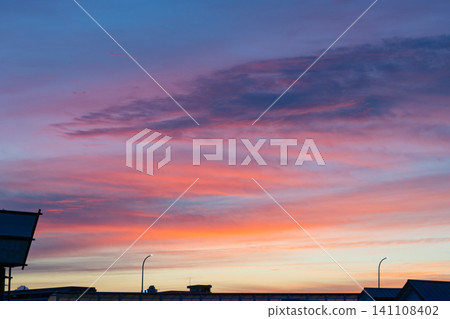 A landscape of city silhouettes against a sunset sky A landscape of city silhouettes against a sunset sky 141108402