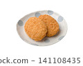 Two croquettes placed on a plate 141108435