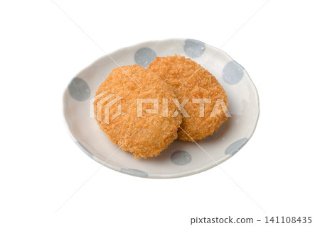 Two croquettes placed on a plate Two croquettes placed on a plate 141108435