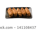 Inari sushi placed on a plate 141108437