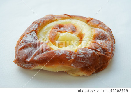 A traditional ensaimada filled with custard cream. A traditional ensaimada filled with custard cream. 141108769