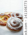 A close-up photo of several traditional sweet buns, ensaimadas. 141108773
