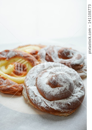 A close-up photo of several traditional sweet buns, ensaimadas. A close-up photo of several traditional sweet buns, ensaimadas. 141108773