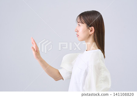 A young woman holding her hand A young woman holding her hand 141108820