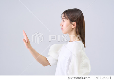 A young woman holding her hand A young woman holding her hand 141108821