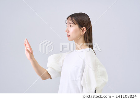 A young woman holding her hand A young woman holding her hand 141108824