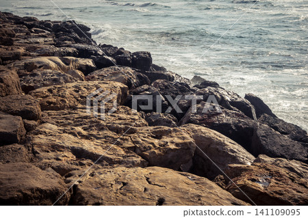 Waves crashing against the rocky coastline with a view of the Mediterranean Sea in Tel Aviv Waves crashing against the rocky coastline with a view of the Mediterranean Sea in Tel Aviv 141109095