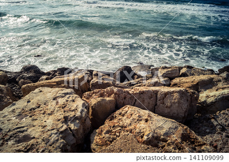 Waves crashing against the rocky coastline with a view of the Mediterranean Sea in Tel Aviv Waves crashing against the rocky coastline with a view of the Mediterranean Sea in Tel Aviv 141109099