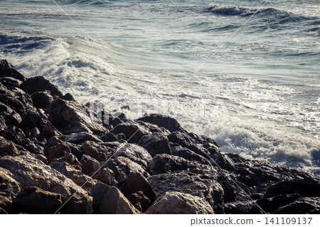 Waves crashing against the rocky coastline with a view of the Mediterranean Sea in Tel Aviv Waves crashing against the rocky coastline with a view of the Mediterranean Sea in Tel Aviv 141109137