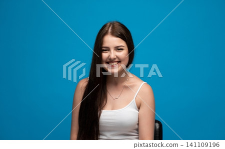 Young, happy woman with long brown hair smiling and looking at camera, feeling positive and cheerful emotions Young, happy woman with long brown hair smiling and looking at camera, feeling positive and cheerful emotions 141109196