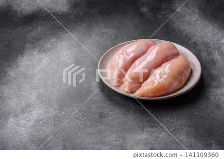 Fresh raw chicken fillet with salt and spices for home cooking. Raw chicken fillet Fresh raw chicken fillet with salt and spices for home cooking. Raw chicken fillet 141109360