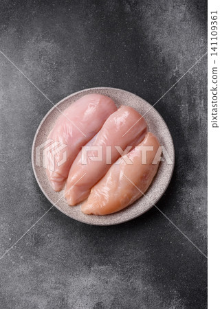 Fresh raw chicken fillet with salt and spices for home cooking. Raw chicken fillet Fresh raw chicken fillet with salt and spices for home cooking. Raw chicken fillet 141109361