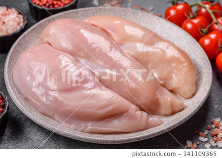 Fresh raw chicken fillet with salt and spices for home cooking. Raw chicken fillet Fresh raw chicken fillet with salt and spices for home cooking. Raw chicken fillet 141109365
