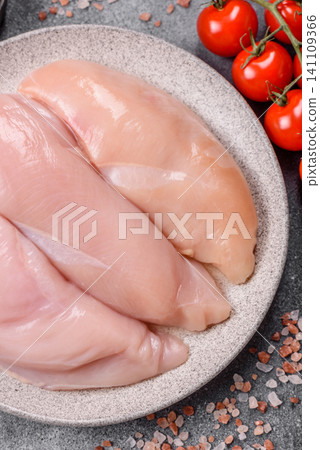 Fresh raw chicken fillet with salt and spices for home cooking. Raw chicken fillet Fresh raw chicken fillet with salt and spices for home cooking. Raw chicken fillet 141109366
