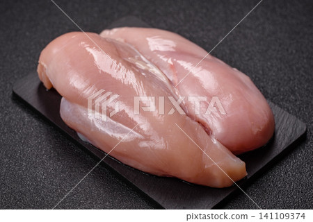 Fresh raw chicken fillet with salt and spices for home cooking. Raw chicken fillet Fresh raw chicken fillet with salt and spices for home cooking. Raw chicken fillet 141109374