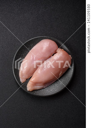 Fresh raw chicken fillet with salt and spices for home cooking. Raw chicken fillet Fresh raw chicken fillet with salt and spices for home cooking. Raw chicken fillet 141109380