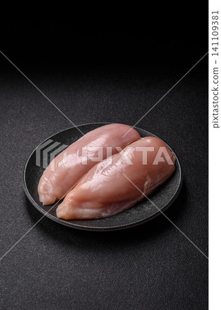 Fresh raw chicken fillet with salt and spices for home cooking. Raw chicken fillet Fresh raw chicken fillet with salt and spices for home cooking. Raw chicken fillet 141109381