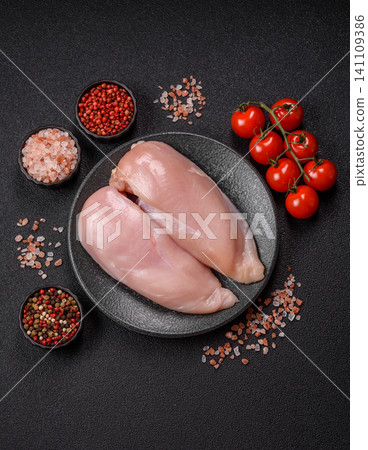 Fresh raw chicken fillet with salt and spices for home cooking. Raw chicken fillet 141109386