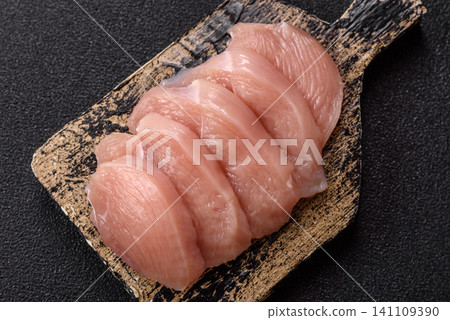Fresh raw chicken fillet with salt and spices for home cooking. Raw chicken fillet Fresh raw chicken fillet with salt and spices for home cooking. Raw chicken fillet 141109390