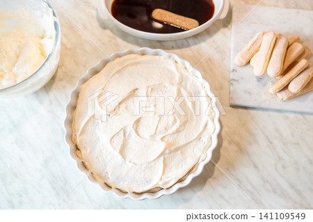 Homemade tiramisu with cream layer on marble surface top view Homemade tiramisu with cream layer on marble surface top view 141109549