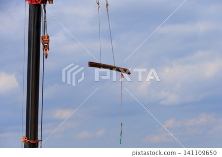 Image of a crane lifting reinforcing bars. Image of a crane lifting reinforcing bars. 141109650