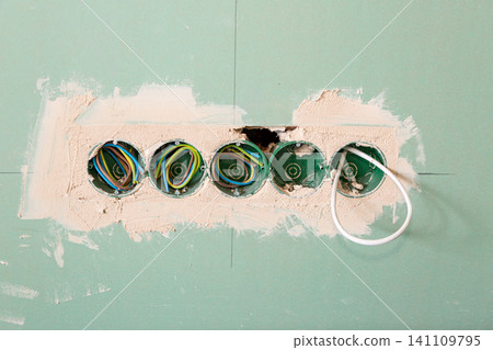 Modern electrical installation on green drywall construction background 141109795
